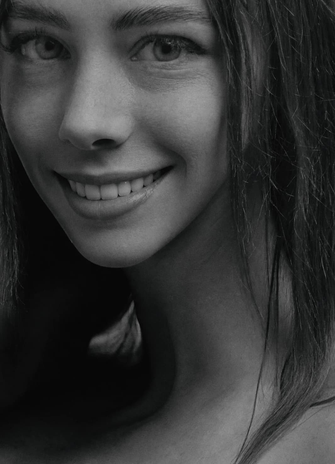 Editorial portrait of a smiling woman with her eyes and teeth visible